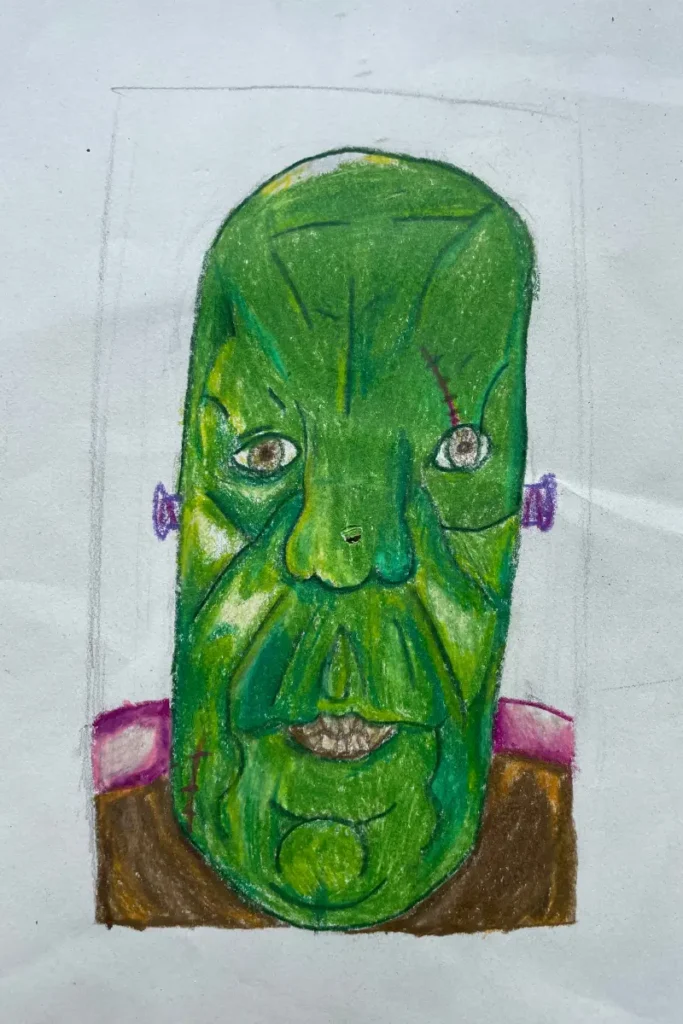 A detailed colored pencil drawing of a green monster's face with exaggerated features.