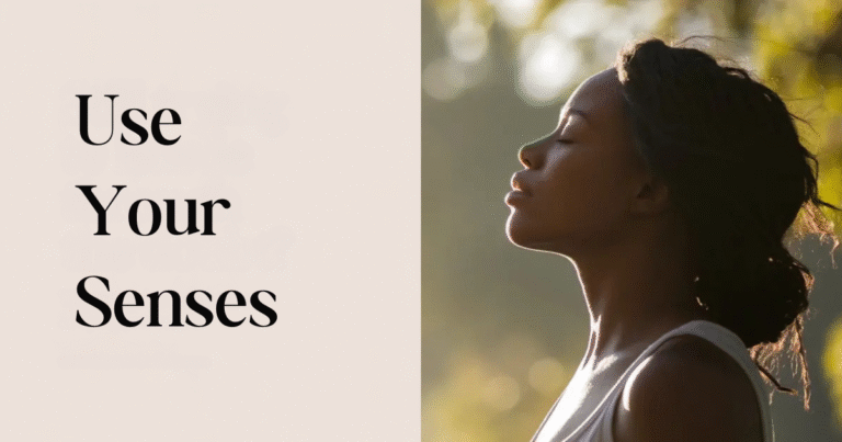 Woman standing outdoors with eyes closed in peaceful sunlight beside the words “Use Your Senses,” symbolizing living with mindfulness, using your senses, and finding calm.