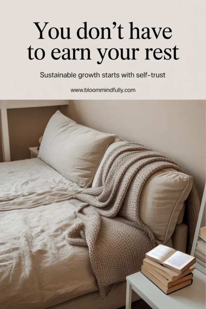 Cozy bed setup with beige bedding, a knit throw, and a stack of books, with the text “You don’t have to earn your rest. Sustainable growth starts with self-trust.” Reflects a sustainable business mindset for mom entrepreneurs.