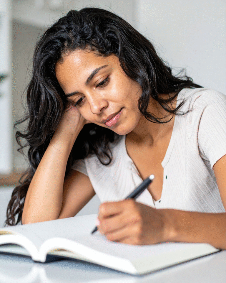 woman writing in journal, quietly reflecting and processing thoughts for clarity